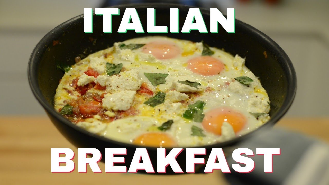 Skillet of baked eggs with ricotta, tomato, and fresh basil, straight from the oven