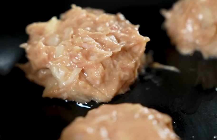 Mixing ground chicken by hand until sticky and fluffy for tsukune