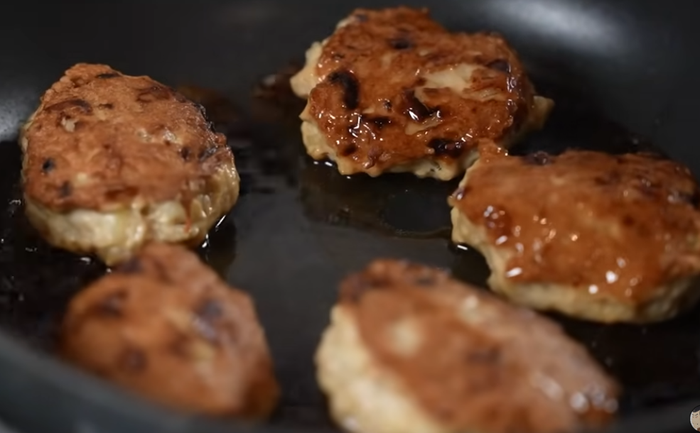 Shaping chicken meatball mixture into balls with lightly oiled hands