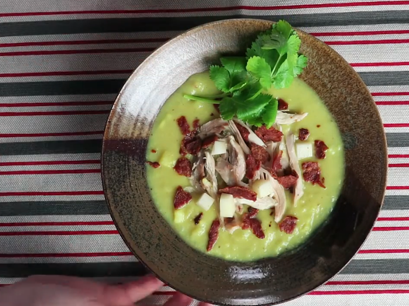 Bowl of creamy cauliflower yam cream chowder topped with crispy bacon and sliced avocado