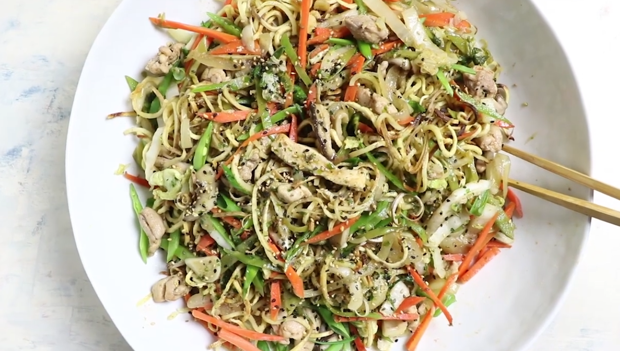 Chicken yakisoba noodles with crispy baked sweet potato noodles, chicken, cabbage, carrots and snow peas topped with scallions