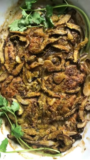 Creamy chicken mushroom casserole in a baking dish with seared chicken breasts, shiitake mushrooms and coconut cream sauce
