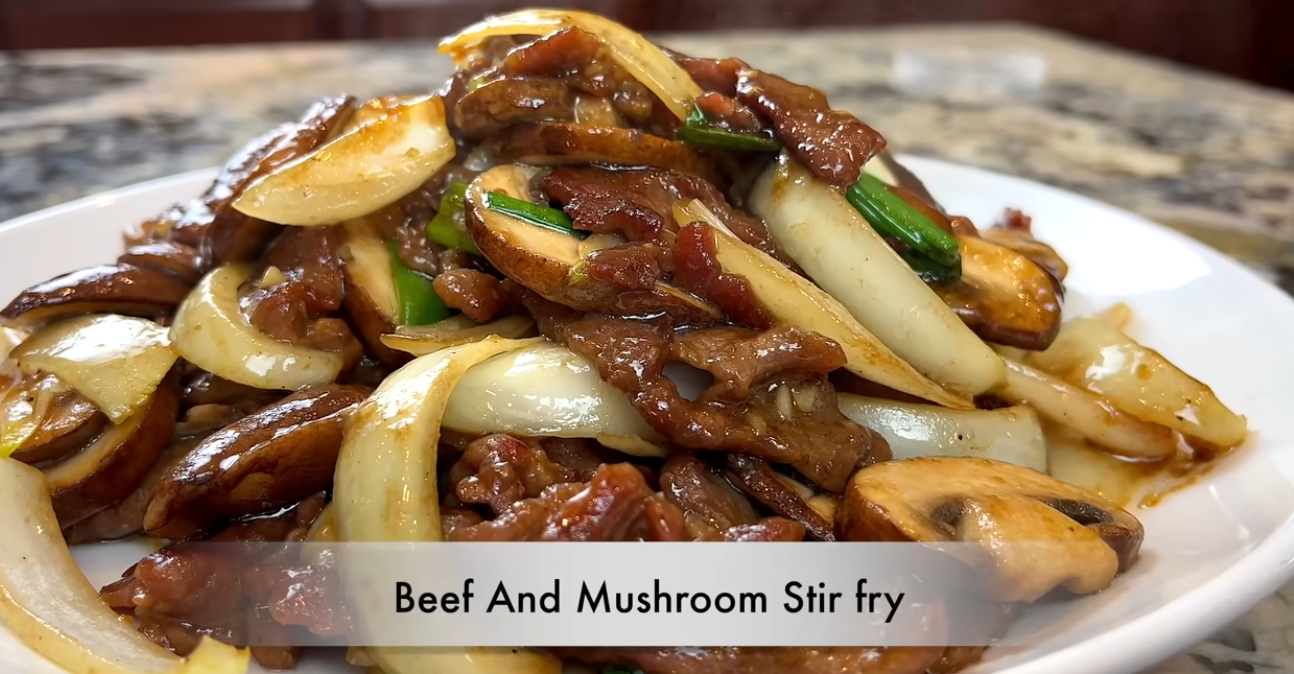 Thai sesame beef mushrooms served on a plate, garnished with scallions and sesame seeds