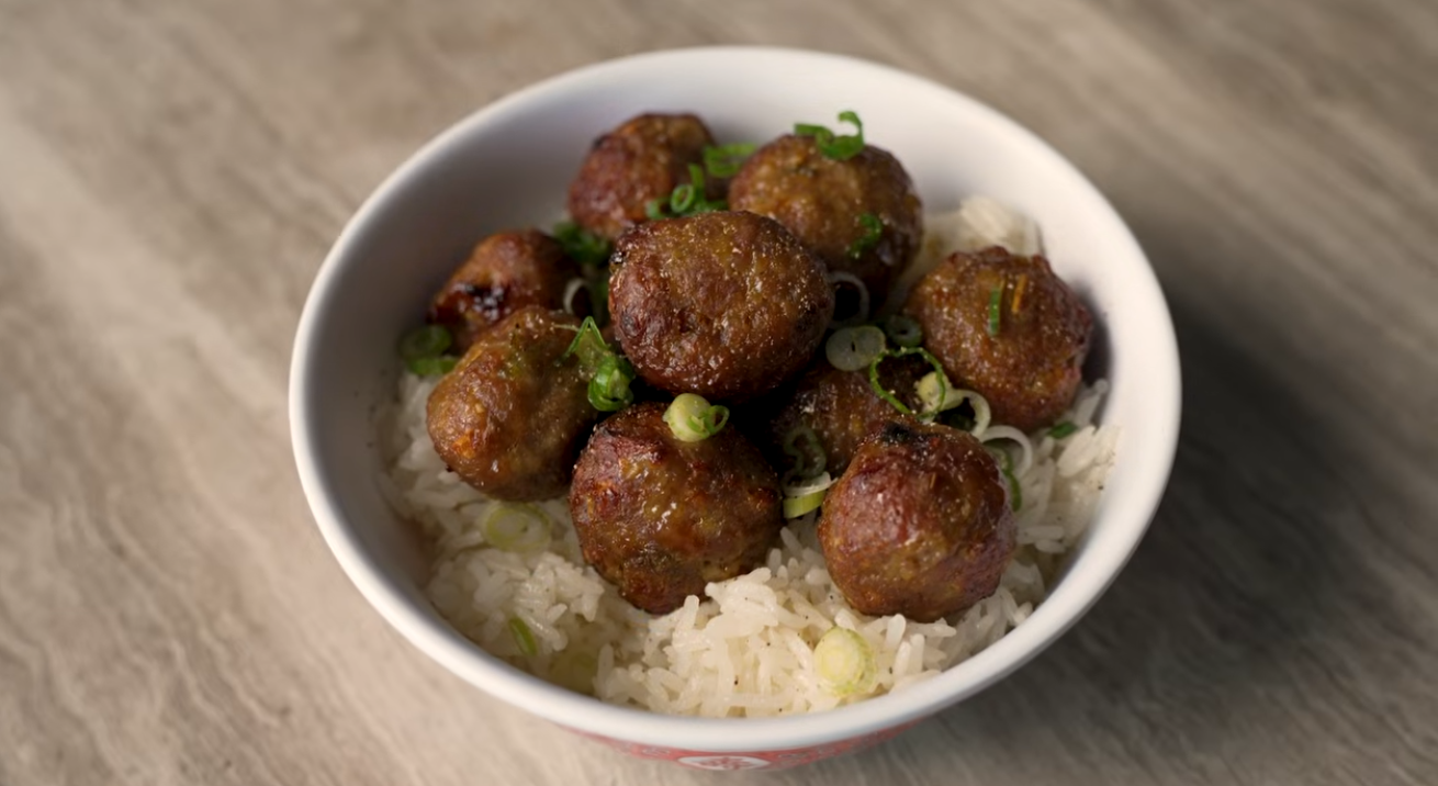 Vietnamese lemongrass meatballs served with dipping sauce, cauliflower rice, cucumbers, and fresh herbs