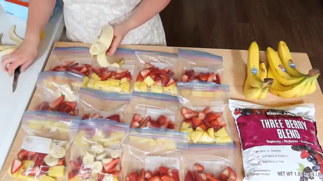 Breakfast burrito filling divided across tortillas before rolling