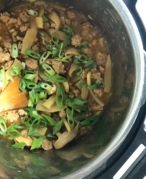 Sliced shallots, scallions, garlic and shiitake mushrooms prepped for meat sauce