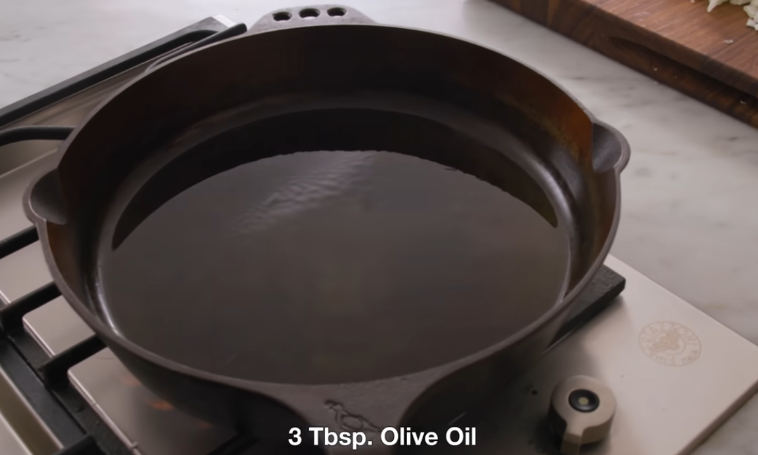 Onions and bell pepper softening in olive oil in a skillet